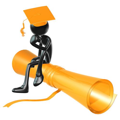 graduate sitting on rolled diploma graduation