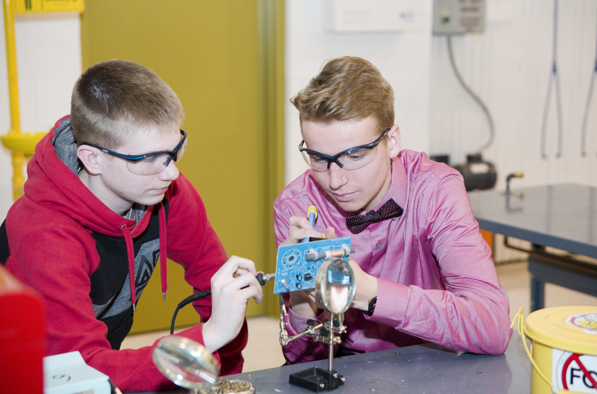Students soldering components