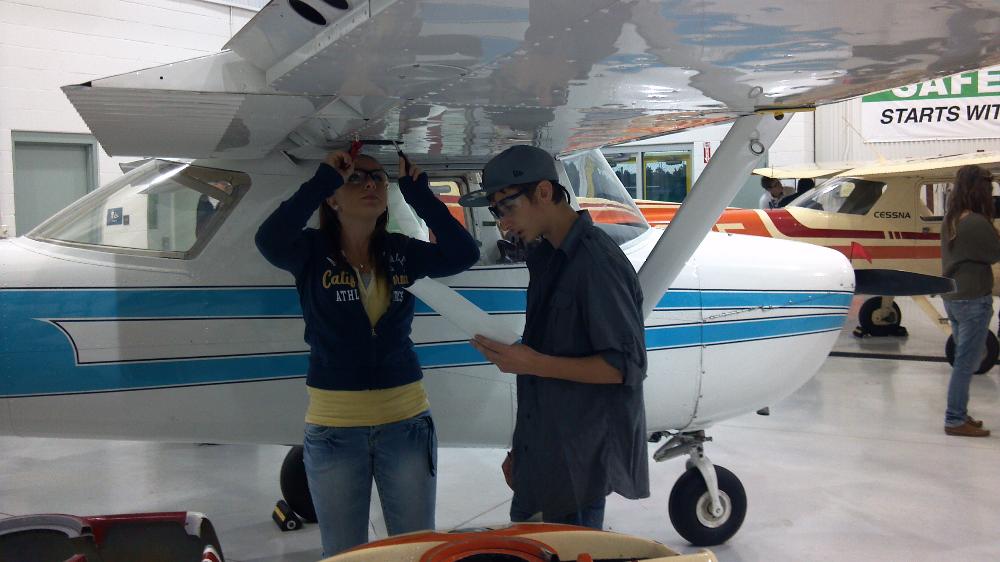 Students practice a mechanical inspection in partnership with the Aviation program.