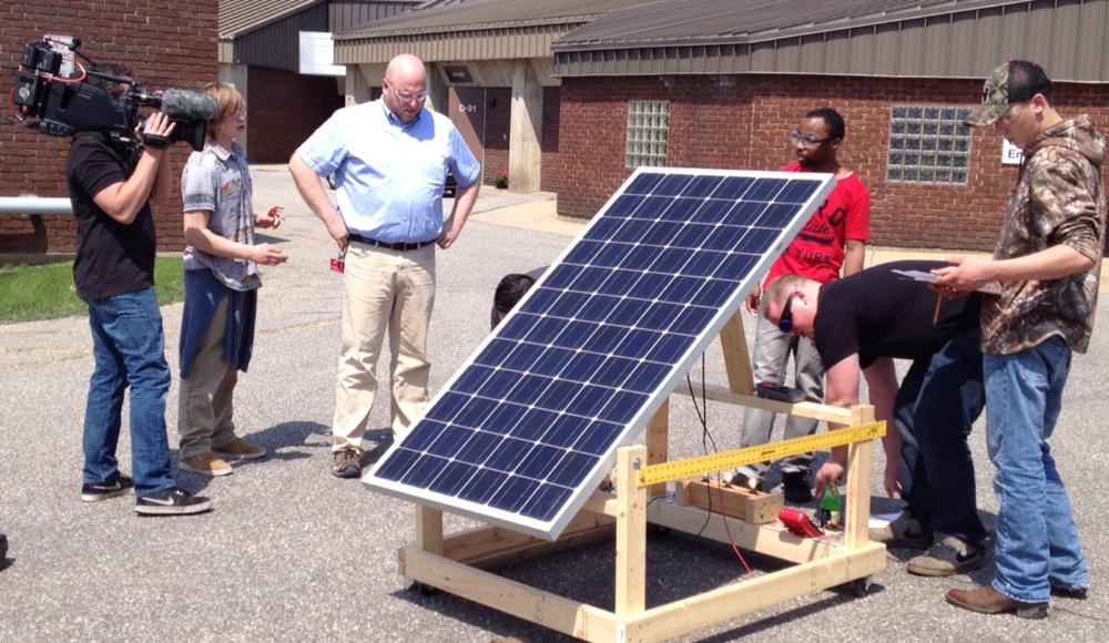 Students demonstrate sighting and operating a solar system for our film crew.
