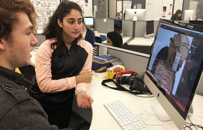 Students work in one of three Year 1 Mac computer labs to prepare projects for printing.