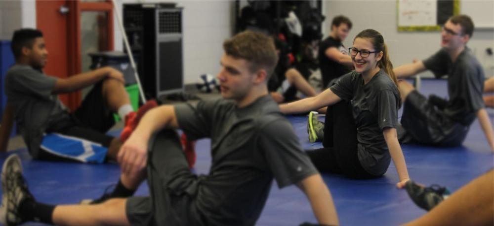 Students stretch in preparation for defensive tactics training.