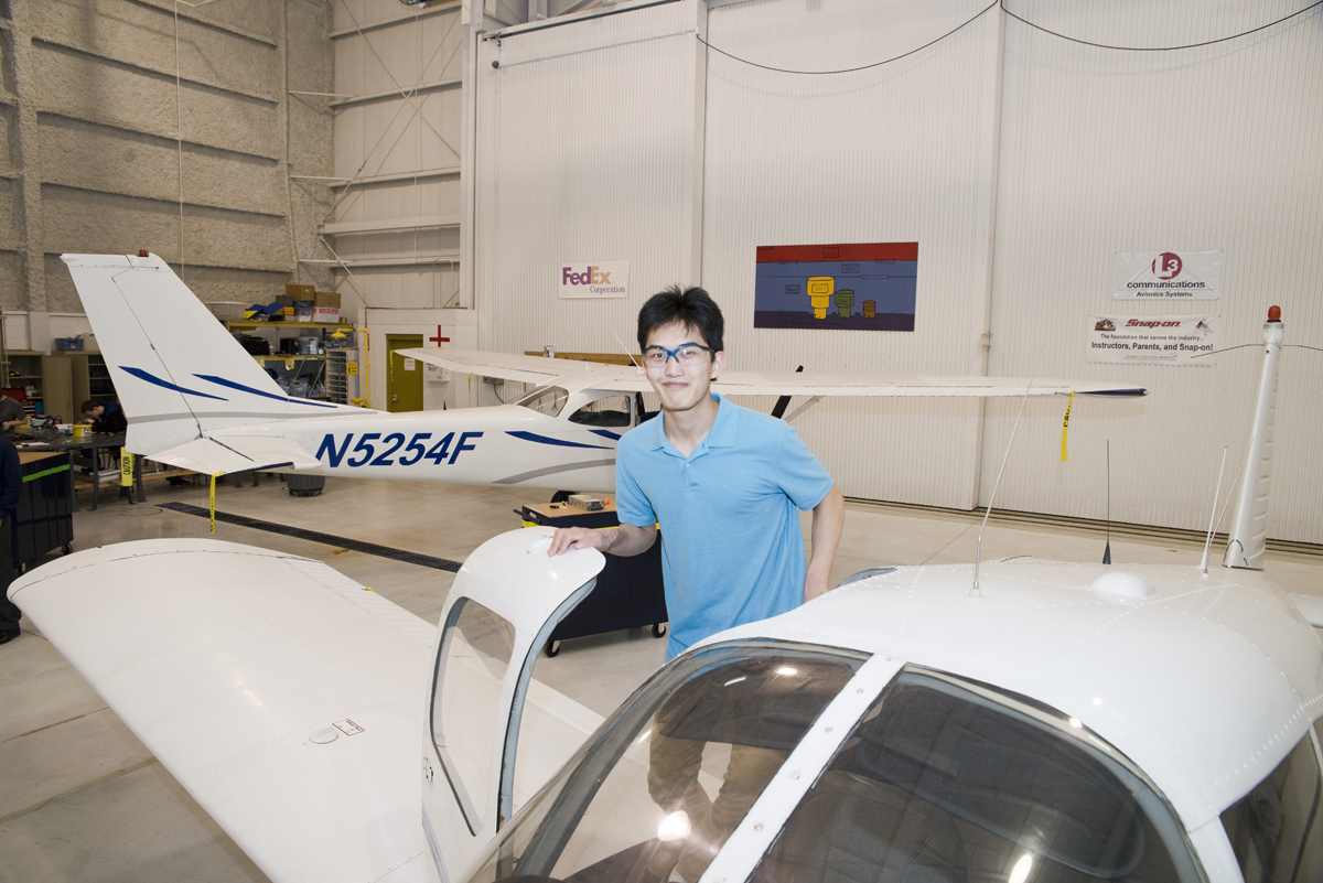 student entering an airplane